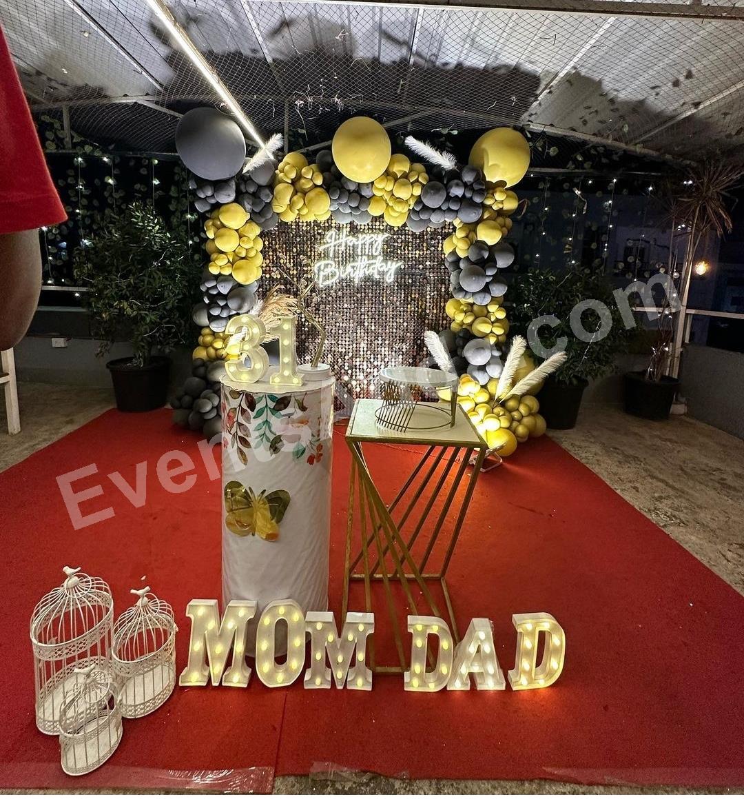 black--gold-shimmer-birthday-backdrop-decoration-with-mom--dad-led-letters in Vijayawada