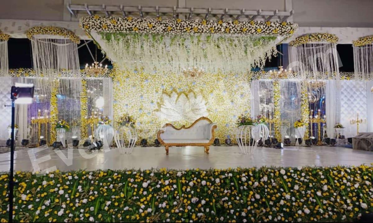 elegant-white--yellow-floral-reception-stage-decoration in Vizag