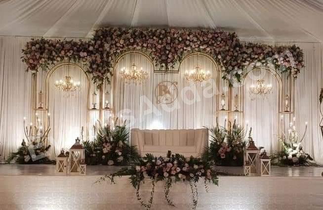 elegant-white-floral-reception-stage-with-arched-backdrop in Warangal Rural