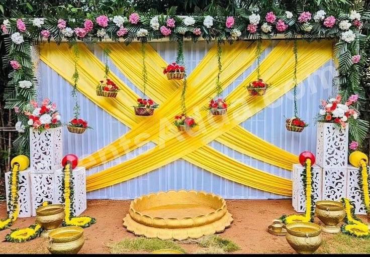 elegant-yellow-draped-floral-haldi-ceremony-decoration in Ahmedabad